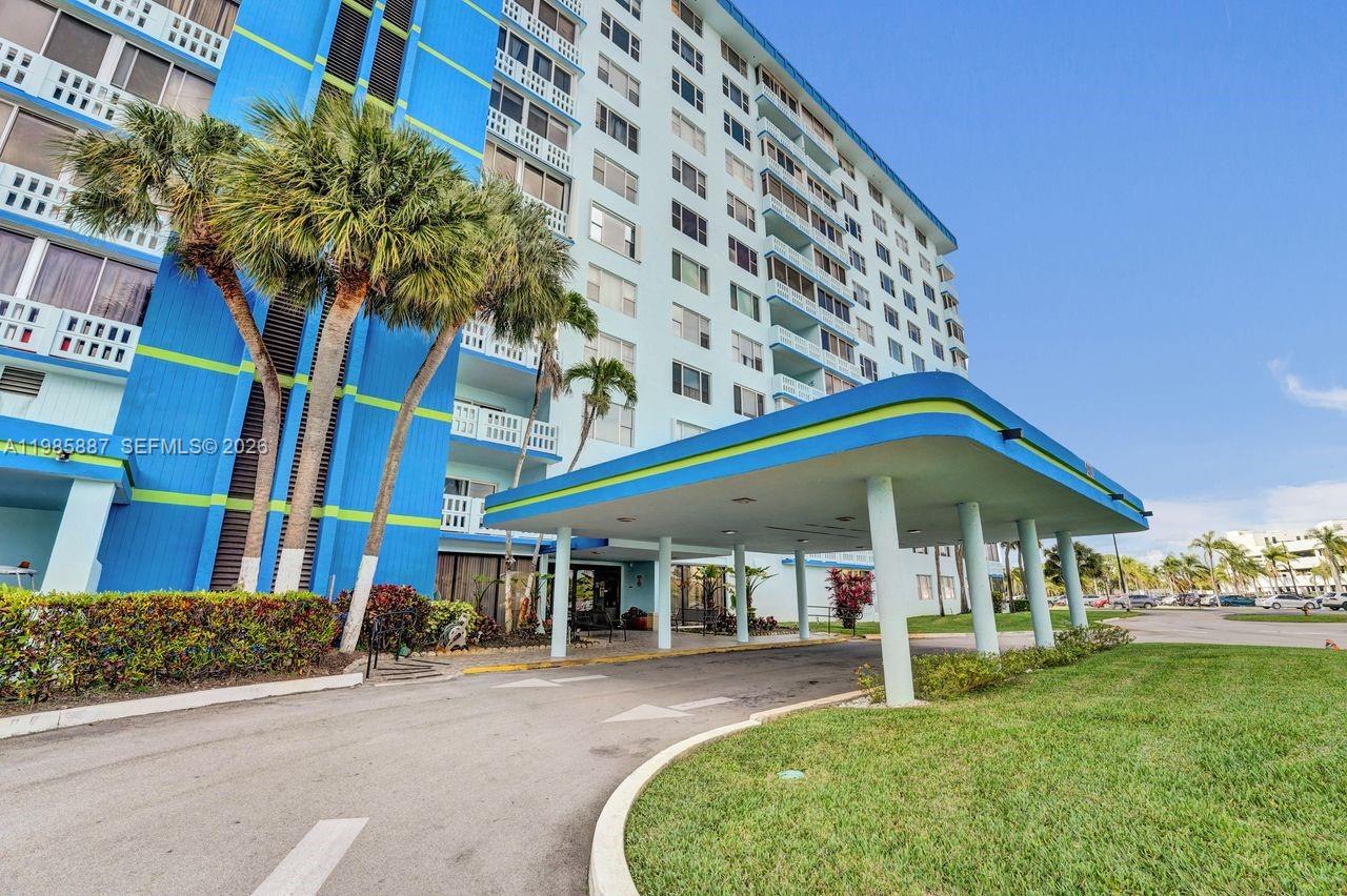 A tall blue apartment building with a covered entrance driveway and palm trees — 4001 Hillcrest Dr # 4, Hollywood FL 33021, HOLLYWOOD, FL
