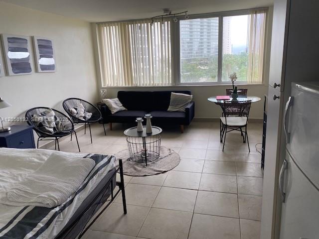 A studio apartment features a bed, a sofa, a small dining set, and large windows — 19201 E Collins Ave # 442, Sunny Isles Beach FL 33160, SUNNY ISLES BEACH, FL