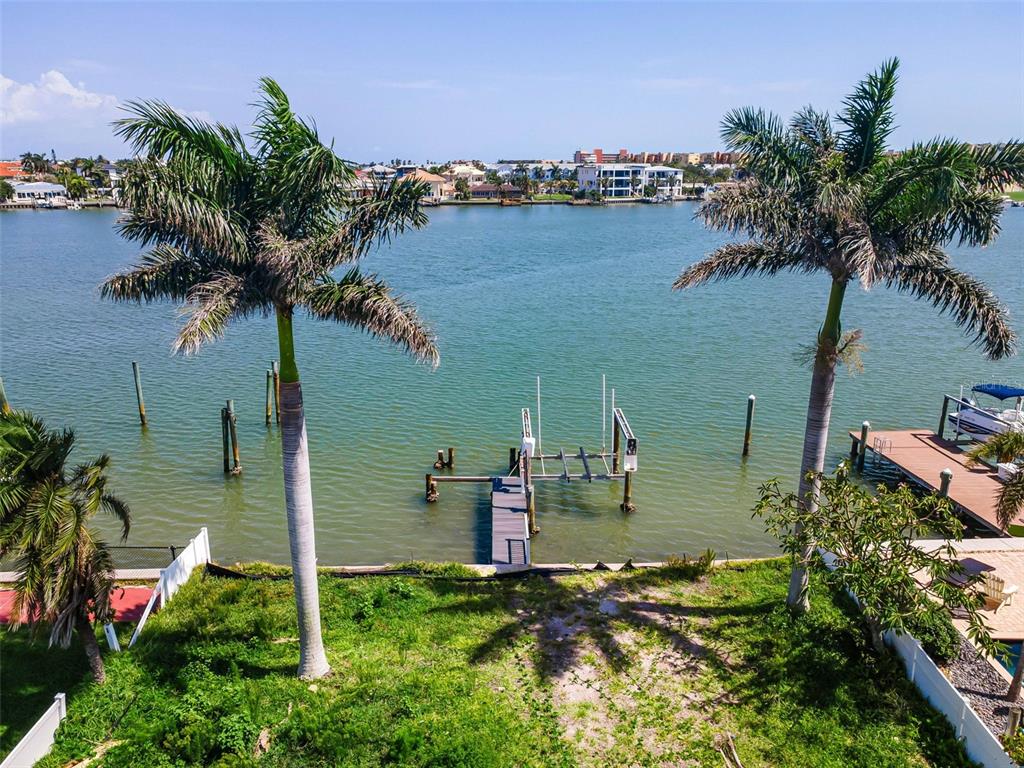 An aerial view of a waterfront lot featuring two palm trees, a dock, and boat lift — 17043 DOLPHIN DRIVE, NORTH REDINGTON BEACH, FL