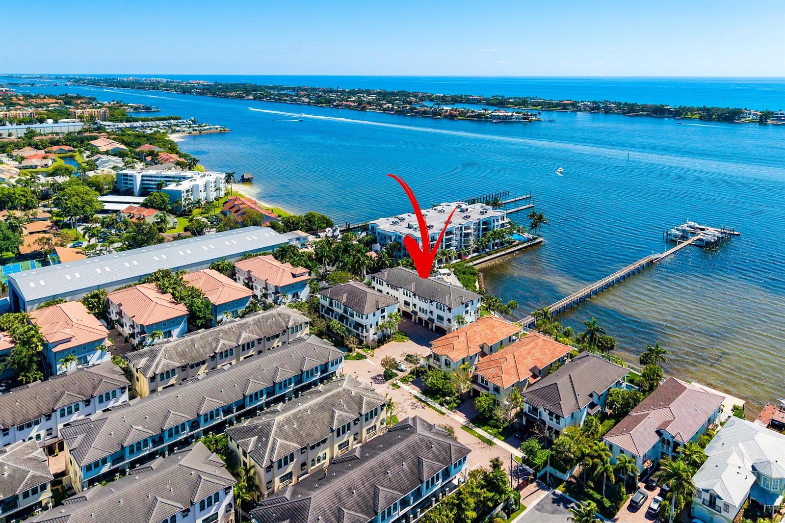 An aerial view shows a waterfront residential complex with a long pier extending into the bay — 10 Windward Lane, Boynton Beach FL 33435, BOYNTON BEACH, FL