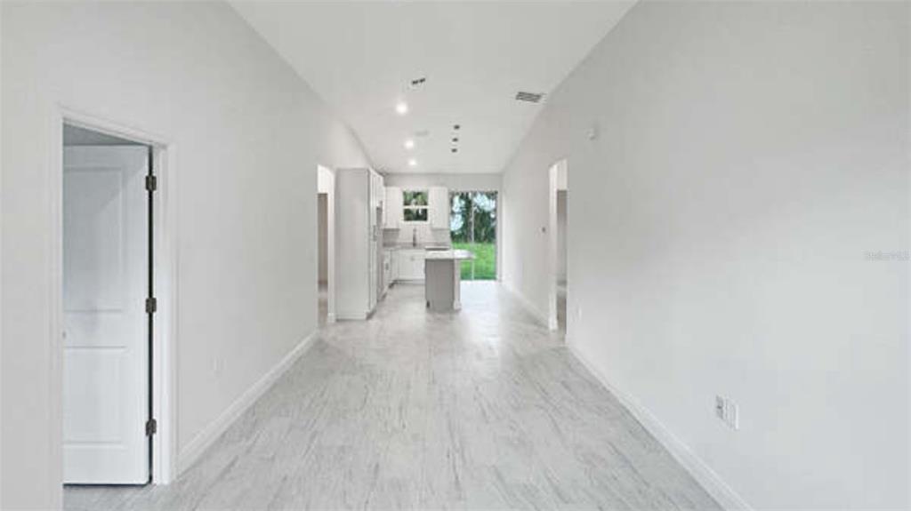 A bedroom features a bed, two nightstands, a mirror, and a potted tree — 3620 WASHINGTON STREET, SANFORD, FL