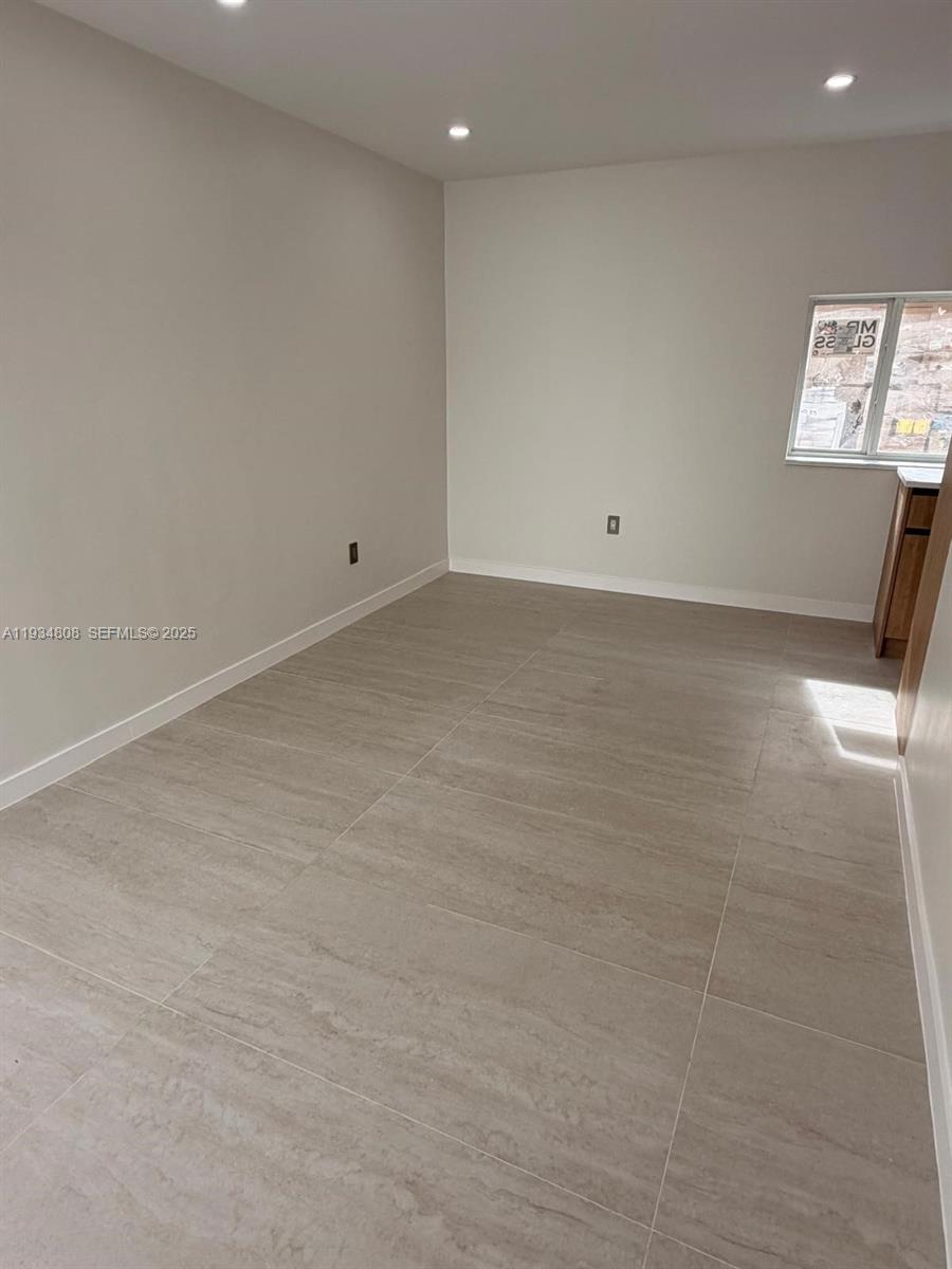 A room with light gray walls, large beige floor tiles, and a window — 2436 SW 7th St # 9, Miami FL 33135, MIAMI, FL