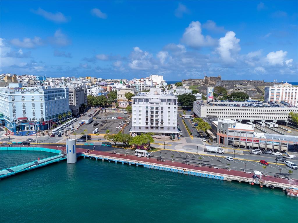 An aerial view of a waterfront city featuring a large hotel, parking lots, and a fortress — 100 REINA DE CASTILLA UNIT 308, SAN JUAN, PR