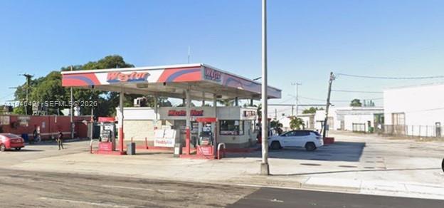 A gas station with a red and blue canopy stands on a paved lot — 14126 NW 27th Ave, Opa-Locka FL 33054, OPA-LOCKA, FL