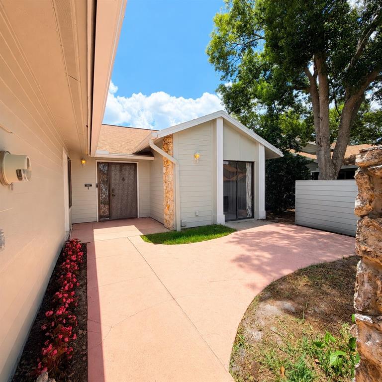 A light-colored house exterior features a front door, a sliding glass door, and a walkway — 229 SURF SCOOTER DRIVE, DAYTONA BEACH, FL