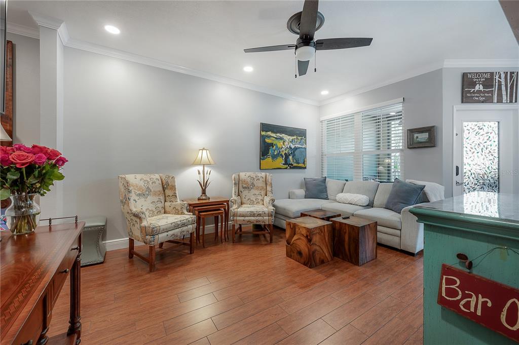 A living room features a sectional sofa, two patterned armchairs, and wood-block coffee tables — 1810 E PALM AVENUE UNIT 4103, TAMPA, FL