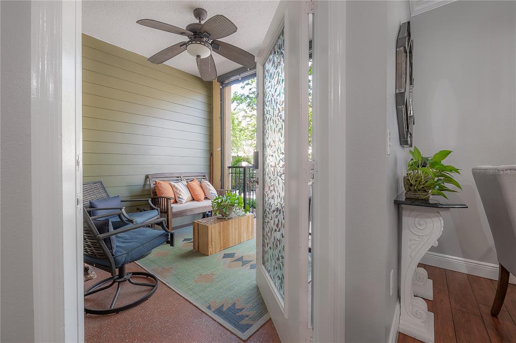 A covered balcony with a ceiling fan, outdoor furniture, and a patterned rug — 1810 E PALM AVENUE UNIT 4103, TAMPA, FL