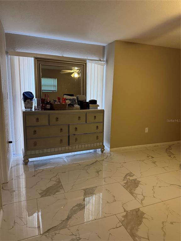 A bedroom features a silver dresser with a mirror against a window with vertical blinds — 1016 KIRK STREET, ORLANDO, FL