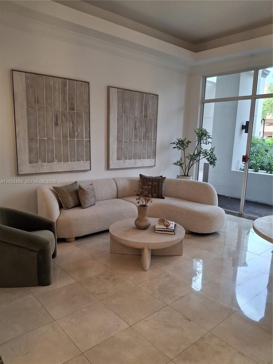 A living room features a curved cream sofa, a round coffee table, and two large artworks — 9021 SW 94th St, Miami FL 33176, MIAMI, FL