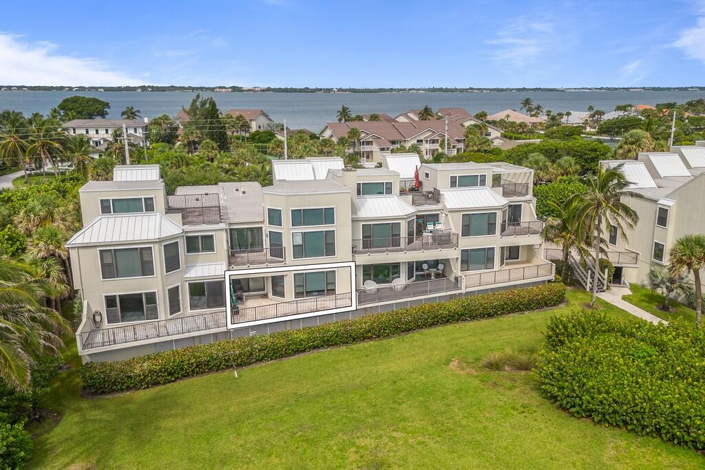 An aerial view of a multi-story waterfront condominium complex with a highlighted balcony — 2051 NE Ocean Boulevard # C13, Stuart FL 34996, STUART, FL