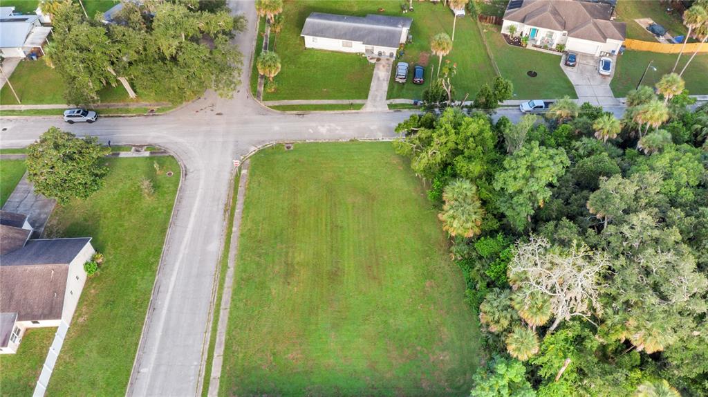 An aerial view shows a vacant, rectangular residential lot situated at a street corner — 4005 VANGUARD AVENUE, TITUSVILLE, FL