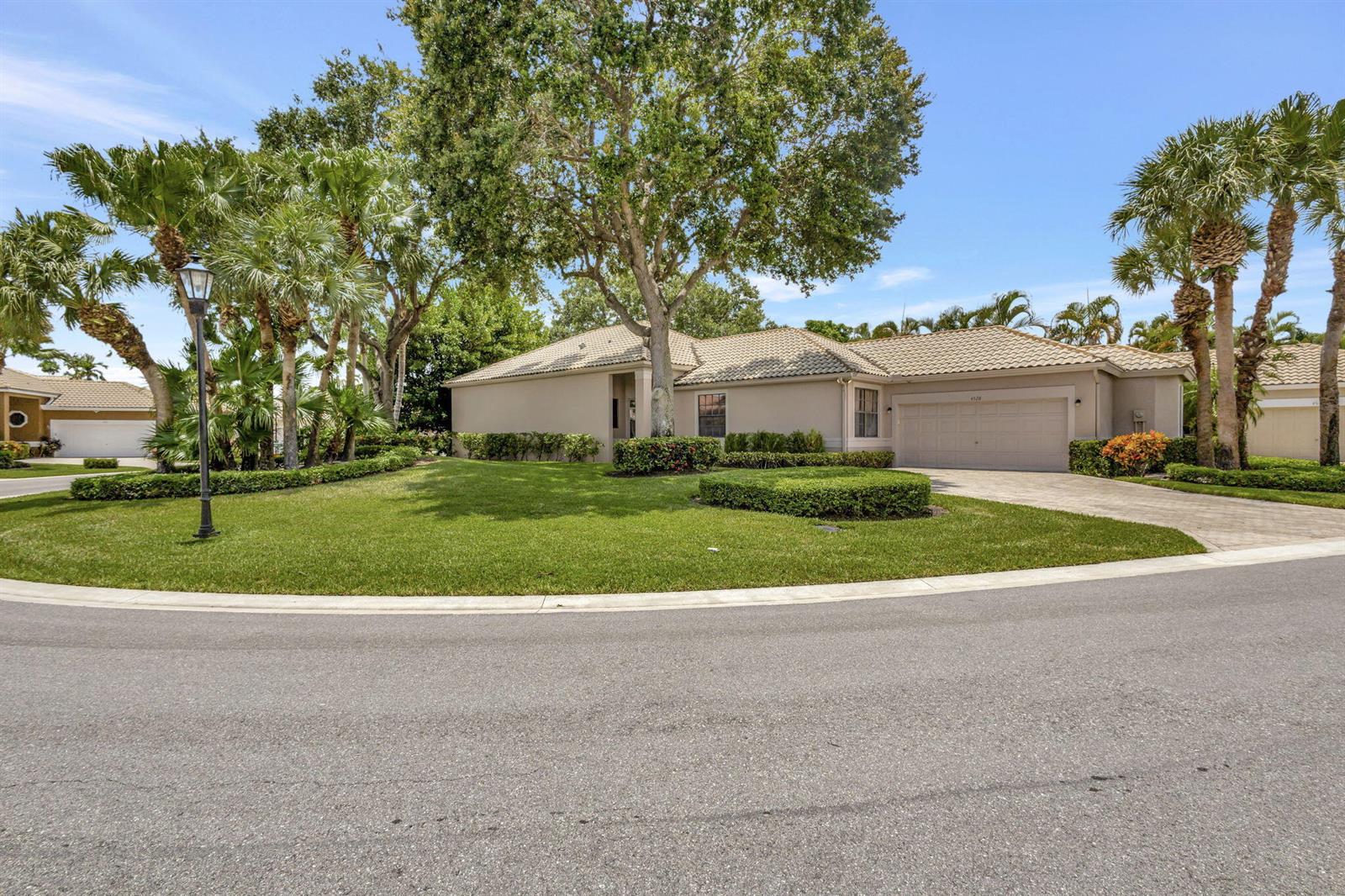 A single-story house with a beige exterior, tile roof, and palm trees in the front yard — 4528 Barclay Fair Way, Lake Worth FL 33449, LAKE WORTH, FL