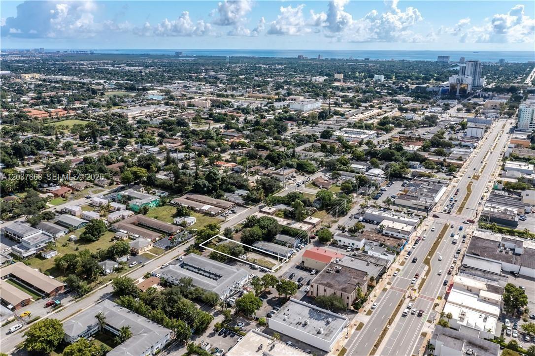 An aerial view shows a rectangular vacant lot outlined in white within a suburban neighborhood — 2434 Polk St, Hollywood FL 33020, HOLLYWOOD, FL