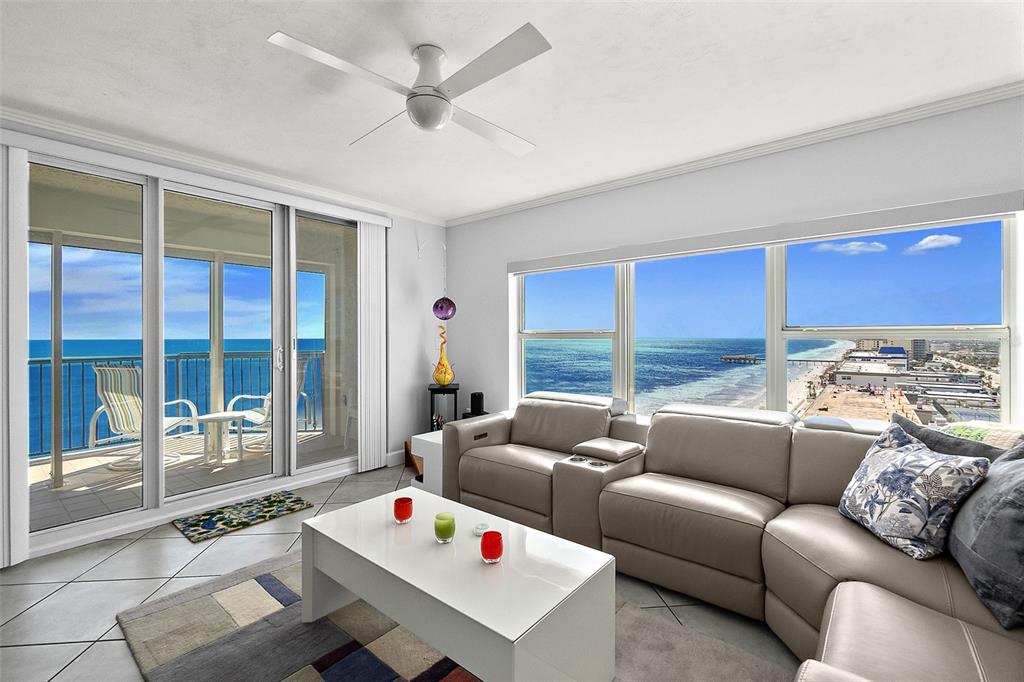 A living room with a beige sectional sofa, white coffee table, and oceanfront balcony views — 3425 S ATLANTIC AVENUE UNIT 1206, DAYTONA BEACH SHORES, FL