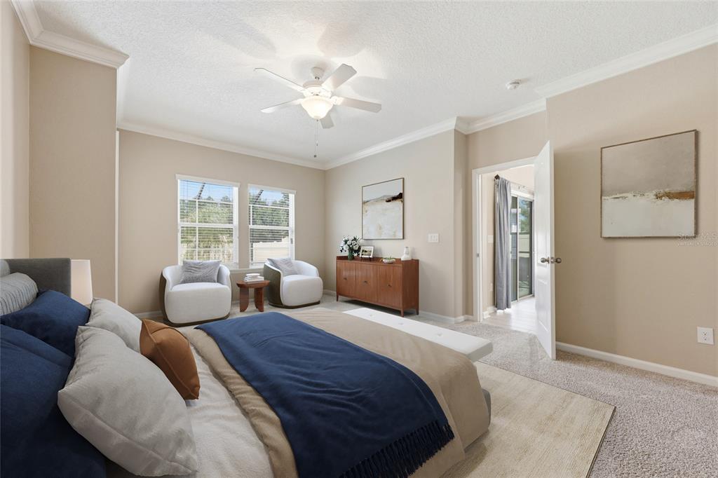 A bedroom features a bed, two armchairs, a wooden sideboard, and a ceiling fan — 2408 LAS CALINAS BOULEVARD, ST AUGUSTINE, FL