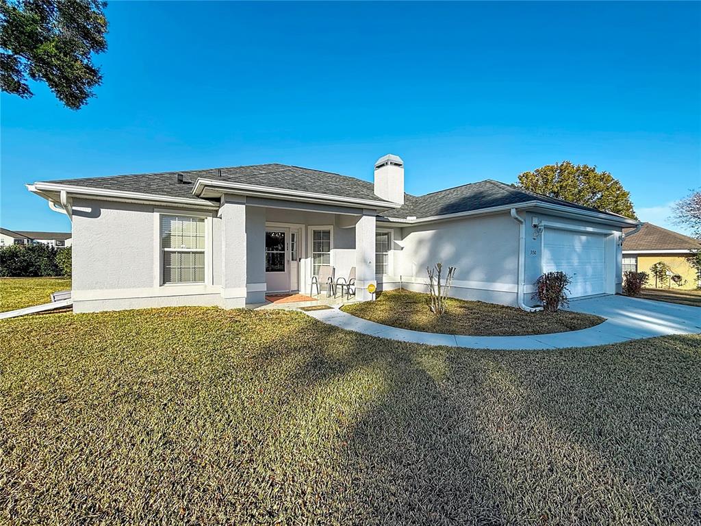 A single-story house with a gray exterior, a front porch, and an attached two-car garage — 3150 NW 50TH COURT, OCALA, FL