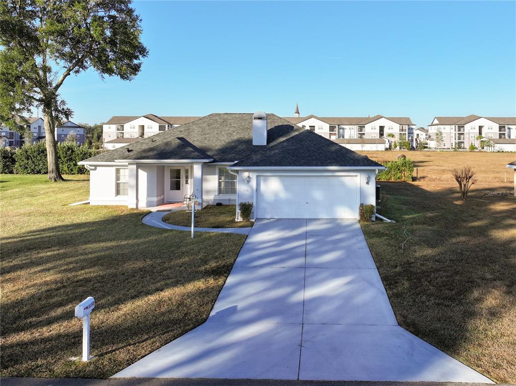 A single-story house with a white exterior, a two-car garage, and a concrete driveway — 3150 NW 50TH COURT, OCALA, FL