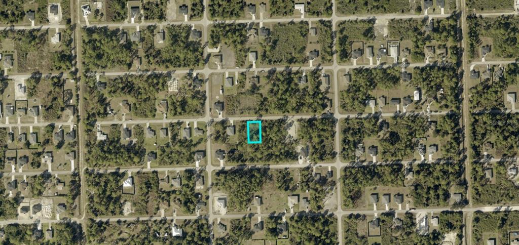 An aerial map view shows a vacant, rectangular residential lot highlighted in blue — 3313 70TH STREET W, LEHIGH ACRES, FL