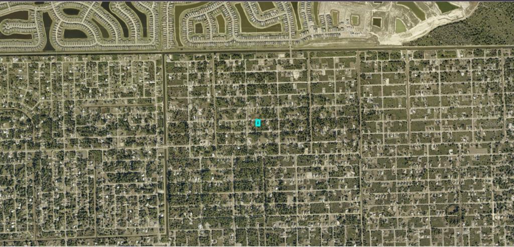 This is an aerial map view of a residential neighborhood with a highlighted property lot — 3313 70TH STREET W, LEHIGH ACRES, FL
