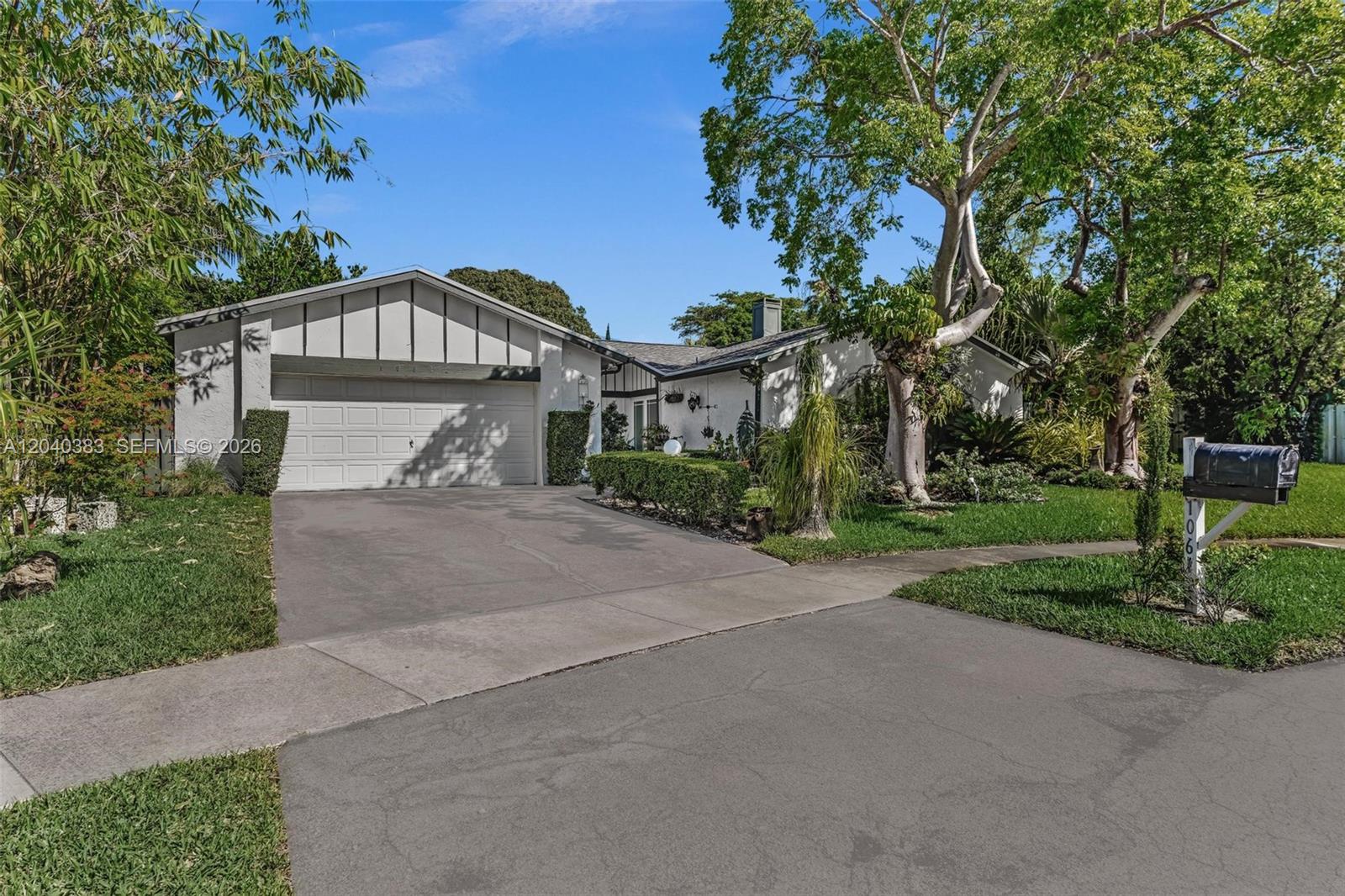 A single-story house with a white exterior, a two-car garage, and a landscaped front yard — 10612 SW 128th Pl, Miami FL 33186, MIAMI, FL