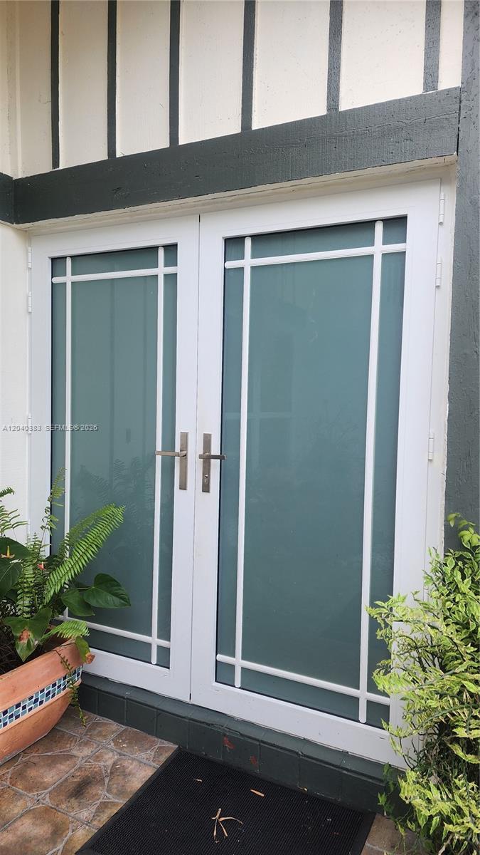 A set of white double doors with frosted glass panels and metal handles — 10612 SW 128th Pl, Miami FL 33186, MIAMI, FL