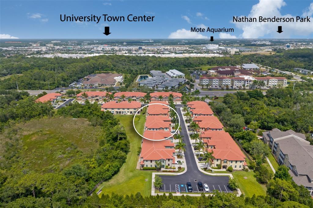 An aerial view shows a residential complex with red-tiled roofs and a circled building — 4968 OARSMAN COURT, SARASOTA, FL