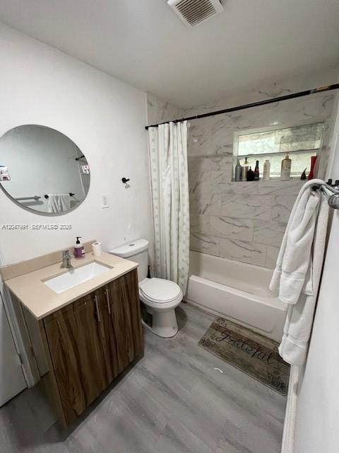 A bathroom features a wood-grain vanity, a white sink, and a tiled walk-in shower — 719 9th St, West Palm Beach FL 33401, WEST PALM BEACH, FL