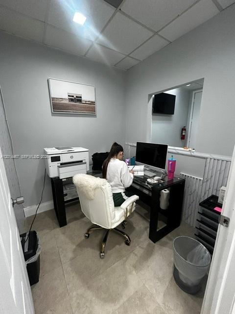 A small home office features a desk, computer, printer, and a person sitting in a chair — 900 W 49th St Suite 420, Hialeah FL 33012, HIALEAH, FL