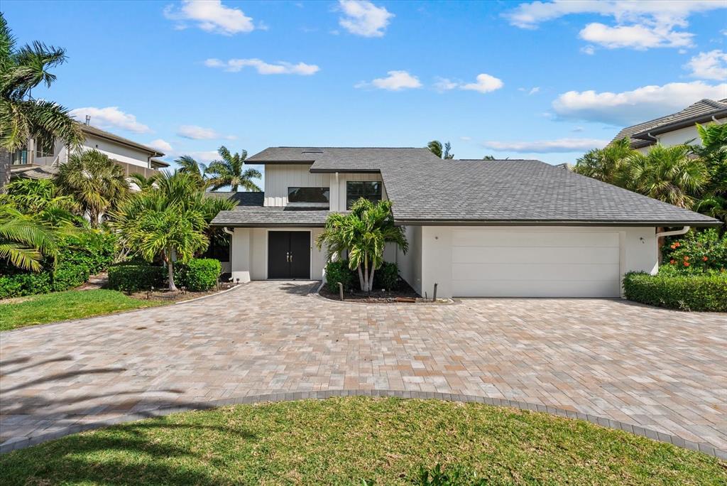 A two-story house with a paved driveway, a two-car garage, and palm trees — 847 FREELING DRIVE, SARASOTA, FL