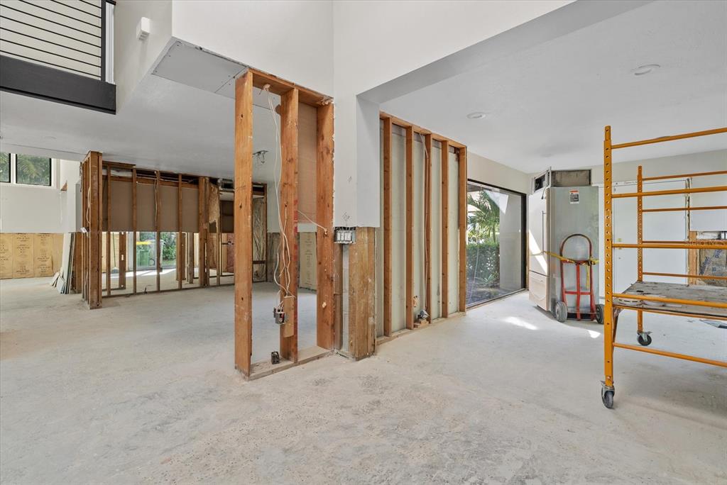 An interior room under construction features exposed wooden wall studs and concrete flooring — 847 FREELING DRIVE, SARASOTA, FL