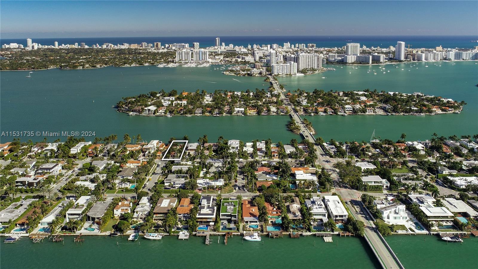 An aerial view shows a residential neighborhood on a waterfront island with a highlighted property — 527 E Dilido Dr, Miami Beach FL 33139, MIAMI BEACH, FL