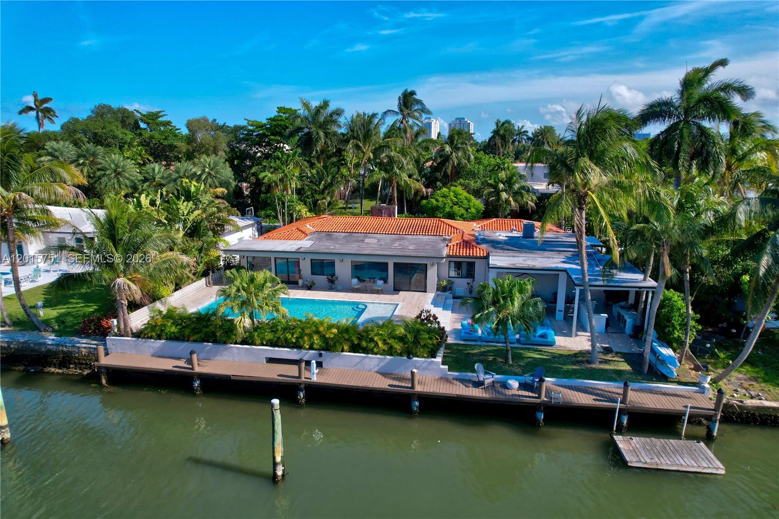 An aerial view of a waterfront house with a swimming pool, patio, and wooden dock — 1141 NE 90th St, Miami FL 33138, MIAMI, FL