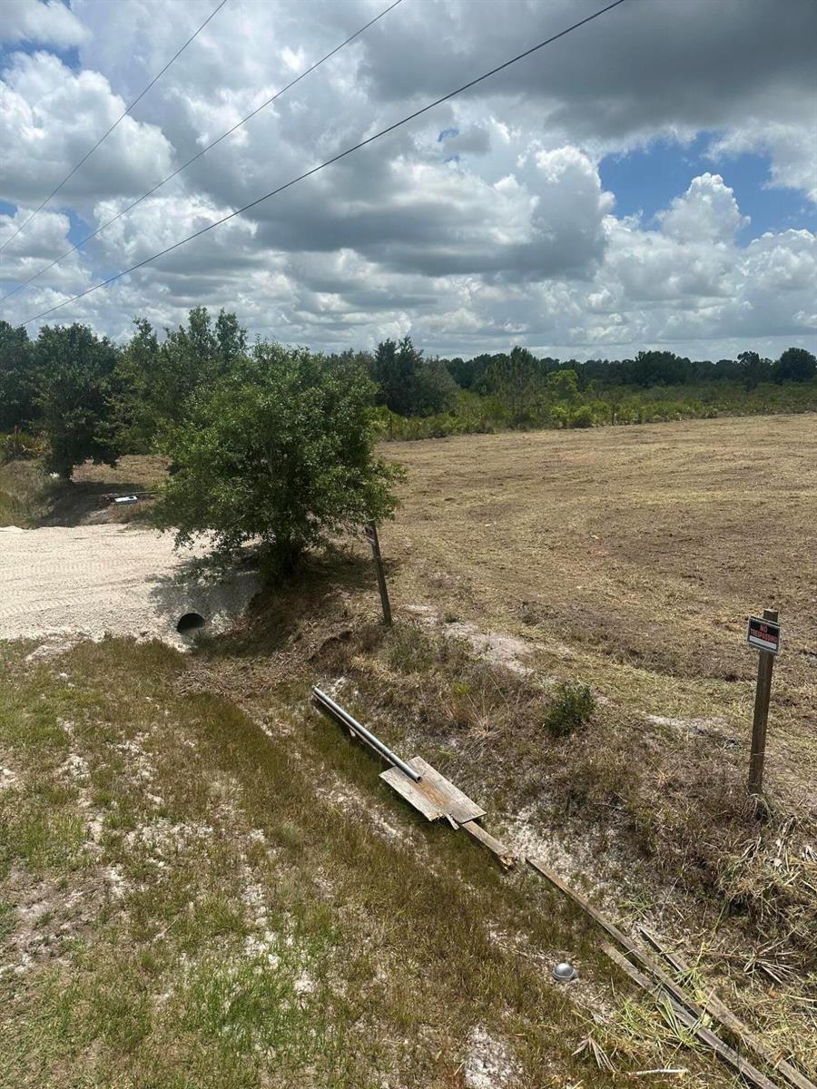 A gravel driveway leads to a cleared, grassy lot with a culvert and drainage ditch — 17980 NW 252nd Street, Okeechobee FL 34972, OKEECHOBEE, FL