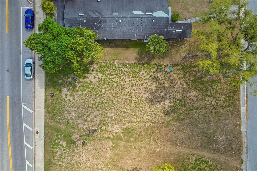 An aerial view shows a vacant rectangular lot situated between a road and a building — 0 DR MARTIN LUTHER KING JR WAY, SARASOTA, FL