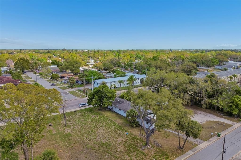 An aerial view shows a residential lot with a house, trees, and surrounding neighborhood streets — 0 DR MARTIN LUTHER KING JR WAY, SARASOTA, FL