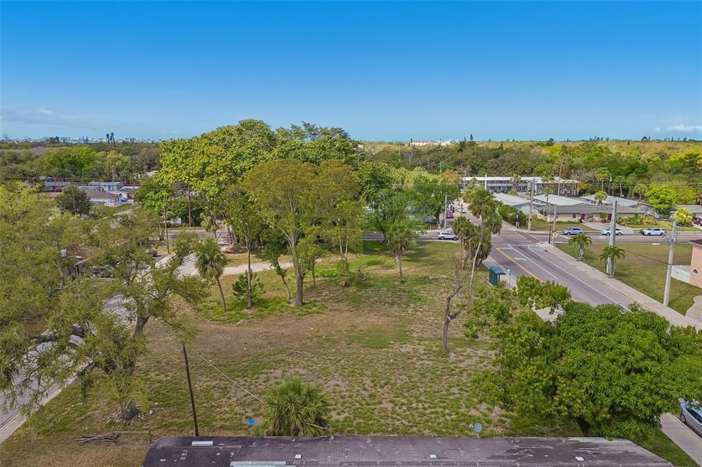 An aerial view shows a vacant, grassy lot surrounded by trees and nearby residential streets — 0 DR MARTIN LUTHER KING JR WAY, SARASOTA, FL