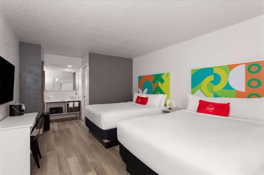 A hotel room features two beds, a desk, and an open-concept vanity area — 5367 W IRLO BRONSON MEMORIAL HWY UNIT 1-103, KISSIMMEE, FL