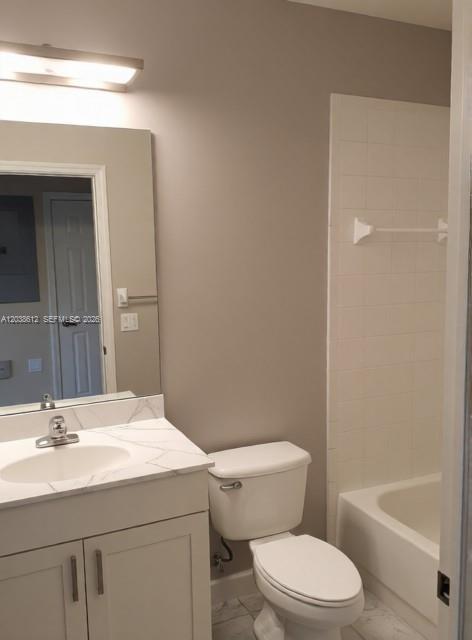 A bathroom features a vanity with a marble countertop, a toilet, and a tiled shower — 3017 Driftwood Way # 0, Naples FL 34109, NAPLES, FL