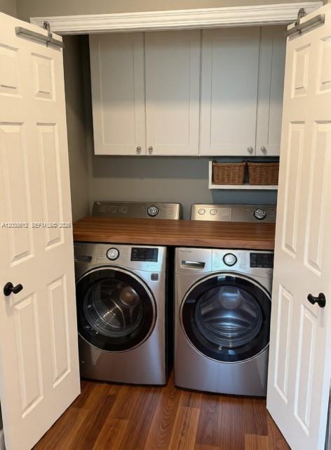 A laundry closet features a wood countertop over stainless steel appliances and white upper cabinets — 3017 Driftwood Way # 0, Naples FL 34109, NAPLES, FL