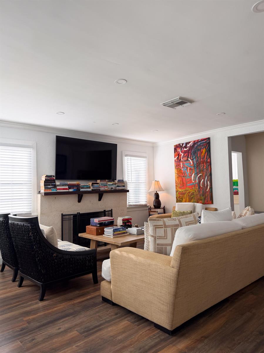 A living room features a fireplace with a television above, a sofa, and two chairs — 521 Hampton Road, West Palm Beach FL 33405, WEST PALM BEACH, FL