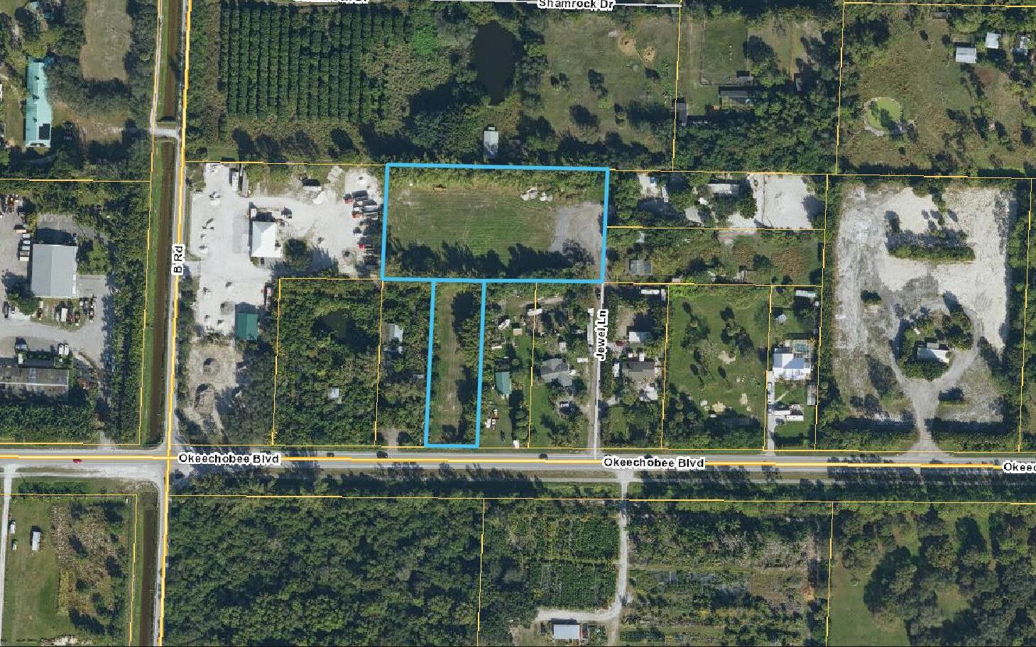 An aerial view shows a vacant, rectangular parcel of land outlined in blue — 2105 Jewel Lane, FL 33470, FL