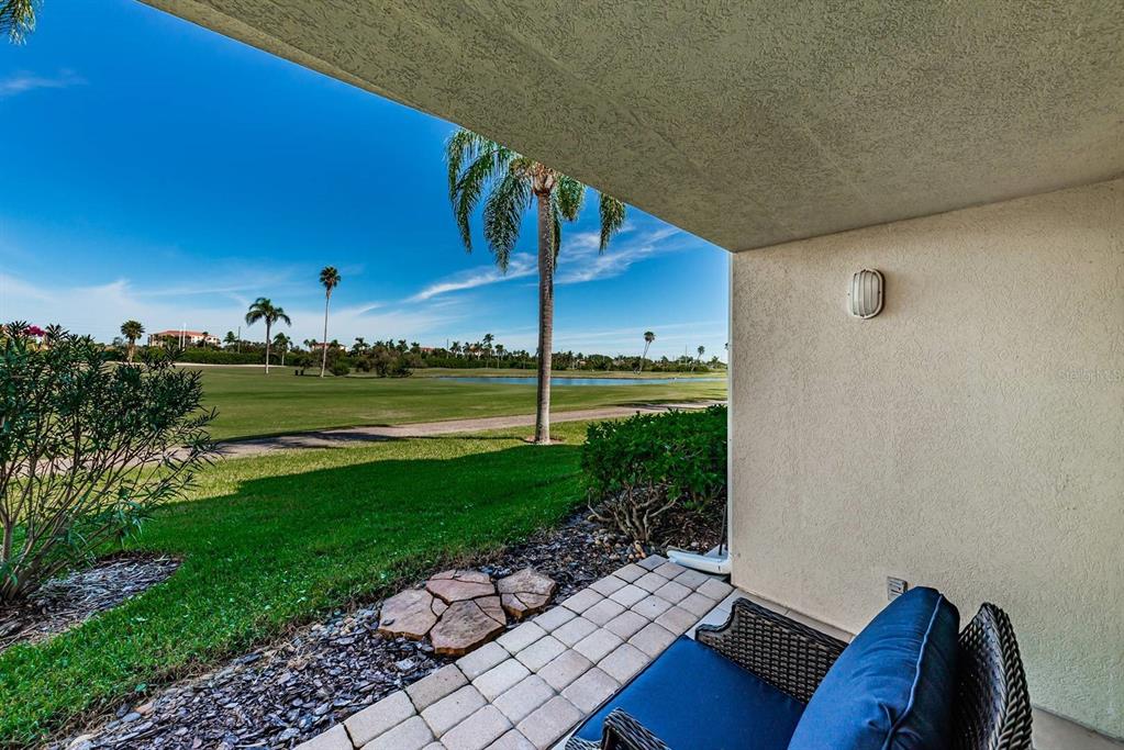 A covered patio overlooks a golf course with a pond and palm trees — 6151 BAHIA DEL MAR BOULEVARD UNIT 120, ST PETERSBURG, FL