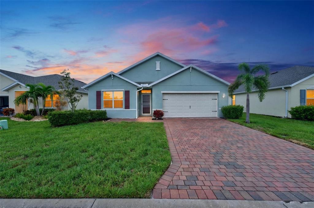 A single-story house with a paved driveway, a two-car garage, and a green lawn — 4107 MANATEE LANE, PORT CHARLOTTE, FL