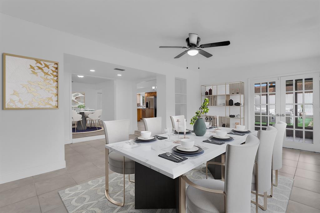 A dining room features a marble-topped table, upholstered chairs, a ceiling fan, and French doors — 3638 JERICHO DRIVE, CASSELBERRY, FL