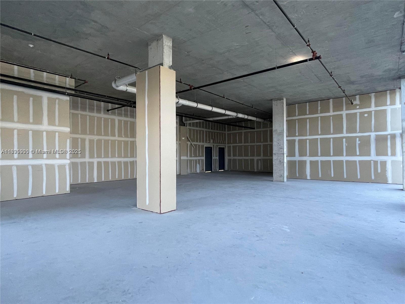 This is an unfinished commercial space with exposed concrete ceilings, drywall partitions, and concrete floors — 10450 NW 33rd St # 102, Doral FL 33172, DORAL, FL