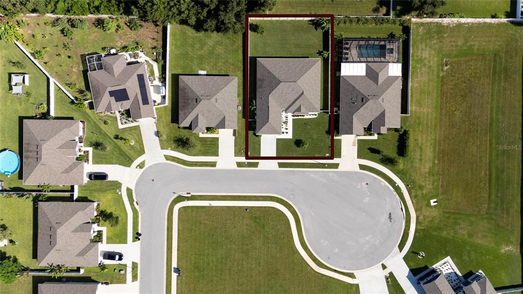 An aerial view shows a residential house with a fenced backyard on a cul-de-sac — 252 SAMANTHA AVE,, AUBURNDALE, FL