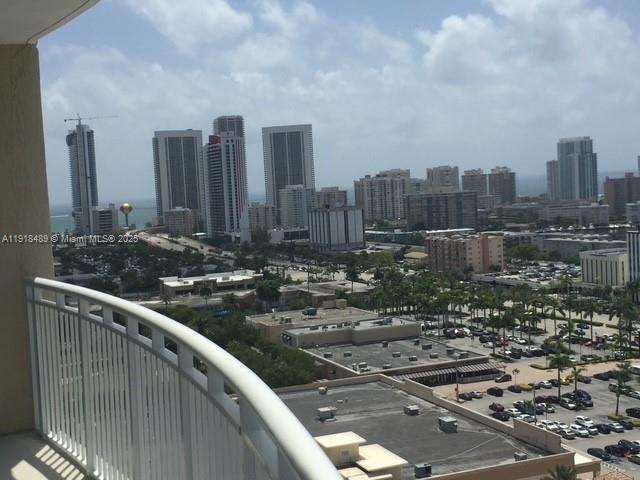 A high-angle view from a balcony overlooking a city skyline and a parking lot — 1745 E Hallandale Beach Blvd # 1807W, Hallandale Beach FL 33009, HALLANDALE BEACH, FL