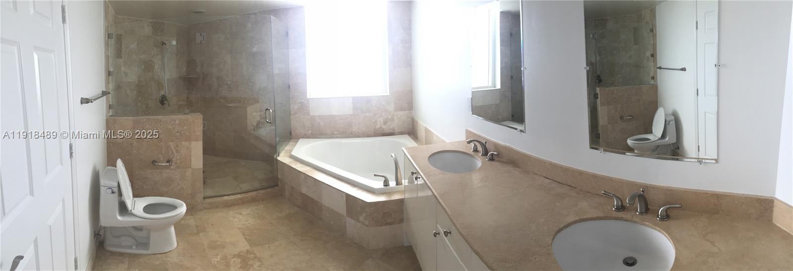 A bathroom features a double vanity, a corner soaking tub, a shower, and two toilets — 1745 E Hallandale Beach Blvd # 1807W, Hallandale Beach FL 33009, HALLANDALE BEACH, FL