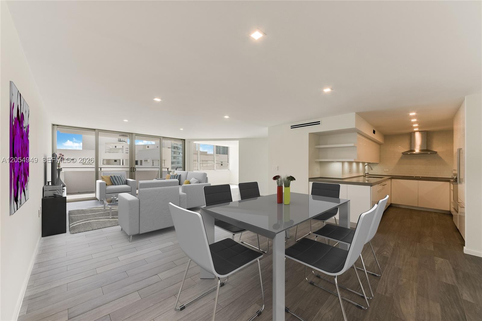 This open-concept living and dining area features a modern kitchen and light wood flooring — 11 Island Ave # 908, Miami Beach FL 33139, MIAMI BEACH, FL