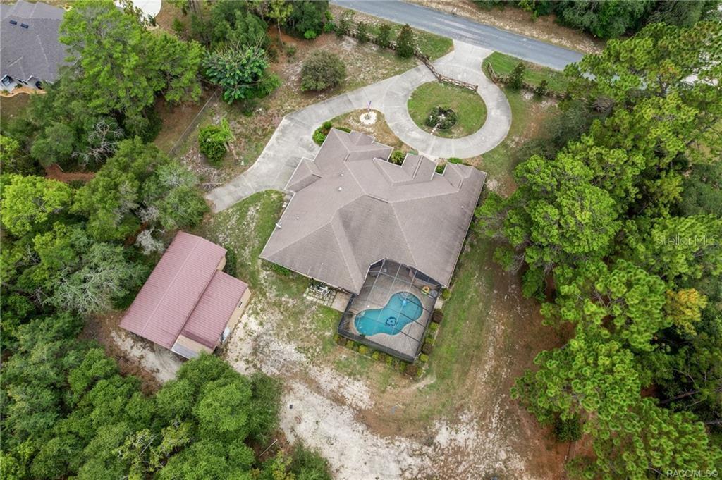 An aerial view of a house with a pool, detached garage, and circular driveway — 4847 W GEYSER COURT, BEVERLY HILLS, FL